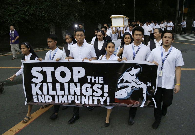 FILE - In this Aug. 29, 2018, file photo, seminarians and nuns carry slogans and a mock coffin during a rally in Manila, Philippines, against drug-related killings and martial law. Photo: AP