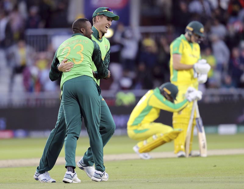 South Africa's Andile Phehlukwayo (left) celebrates with teammate Dwaine Pretorius after beating Australia during the Cricket World Cup match between Australia and South Africa at Old Trafford in Manchester, England, Saturday, July 6, 2019. Photo: AP