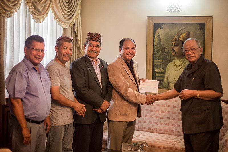 BK Shrestha handing the cheque to Shree Bhimsen Temple Rebuilding Committee during a programme, in Lalitpur, on Wednesday, July 10 2019. Photo: Shree Bhimsen Temple Rebuilding Committee