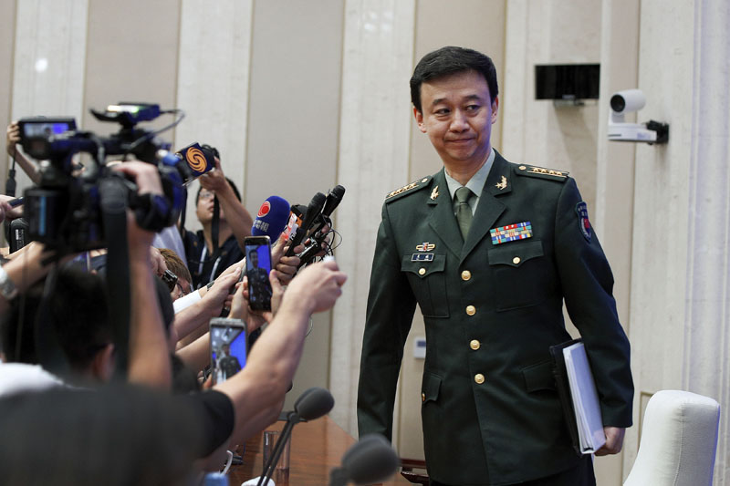 China's Defense Ministry spokesman Wu Qian leaves as journalists are asking question on Hong Kong's recent protests after a press conference at the State Council Information Office in Beijing, Wednesday, July 24, 2019. Photo: AP