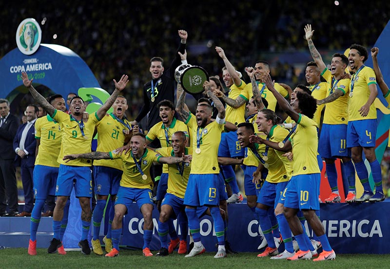 Brazil's Dani Alves and team mates celebrate winning the Copa America with the trophy during the Copa America Brazil 2019 at Final between Brazil and Peru, at Maracana Stadium, in Rio de Janeiro, Brazil, on July 7, 2019. Photo: Reuters