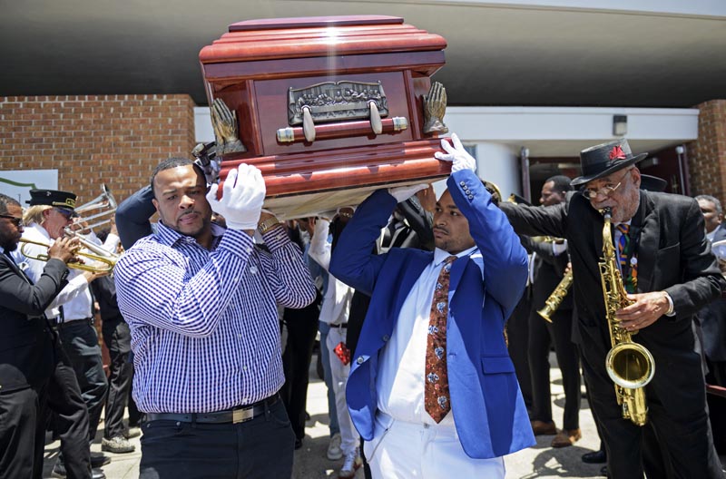 Pallbearers carry the coffin of Dave Bartholomew past the Treme brass band as they exit St Gabriel the Archangel Church at the conclusion of his funeral in New Orleans, Monday, July 8, 2019. Photo: Max Becherer/Times-Picayune via AP