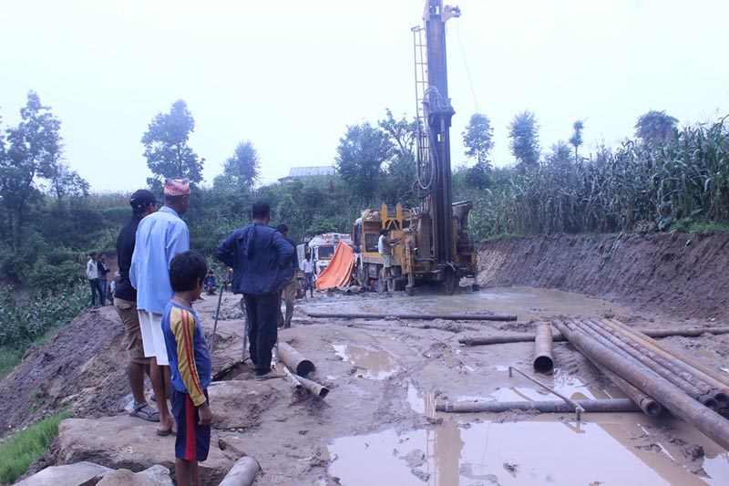 People watching the deep boring system installed to extract ground water in Arun Rural Municipality-5 of Bhojpur district, on Thursday, July 25, 2019. Photo: Niroj Koirala/THT