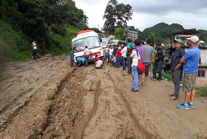 Passengers stranded after vehicles got stuck on a muddy road section along the Araniko Highway in Charikot, headqurters of Dolakha, on Saturday. Photo: THT