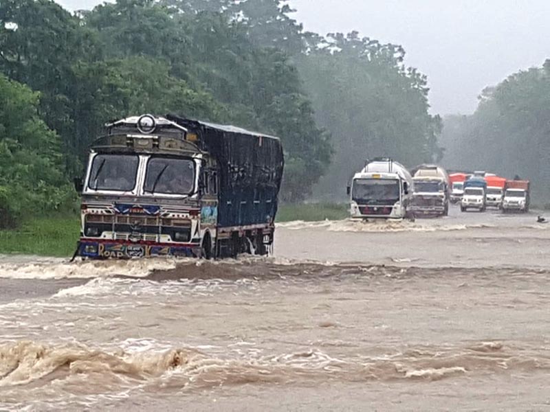 Vehicles wading through the flooded East-West Highway at Chandi Lachka in Rautahat district, on Friday, July 12, 2019. Photo: Prabhat Kumar Jha/THT