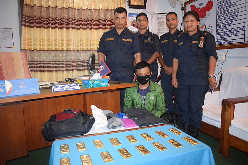 Police making public an alleged gold smuggler along with the seized gold bars at Gorkha District Police Office, in Gorkha, on Thursday, July 25, 2019. Photo: Bharat Koirala/THT