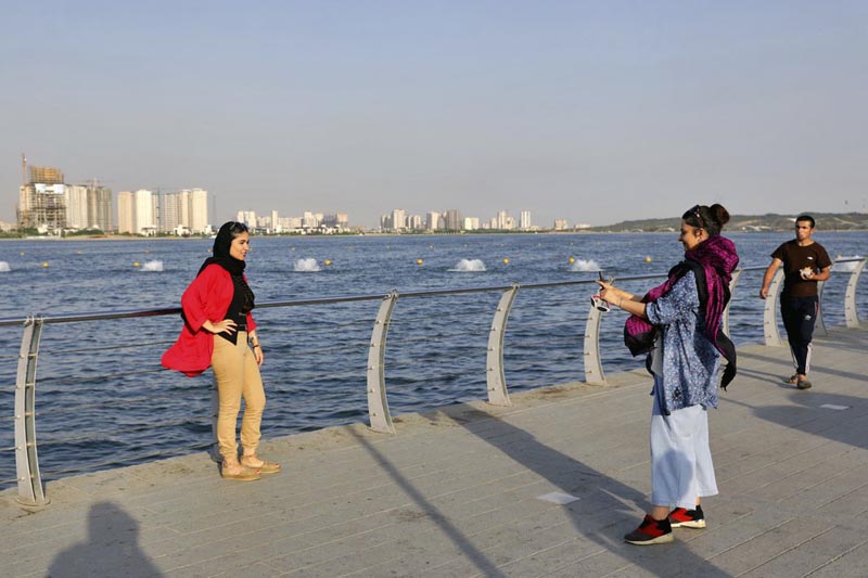 In this Saturday, July 6, 2019 photo, women take memorial picture while spending an afternoon around the Persian Gulf Martyrs' Lake in Tehran, Iran. Photo: AP