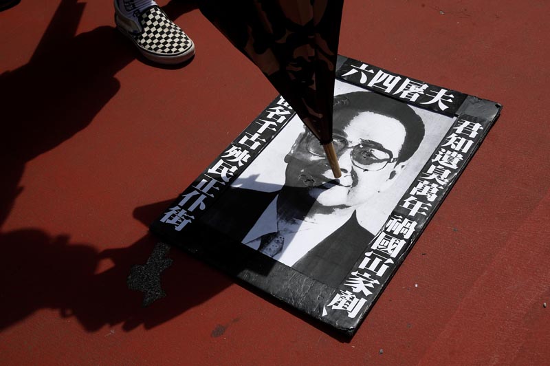 People step and spit at a portrait of former premier of China Li Peng during a protest against the Yuen Long attacks in Yuen Long, New Territories, Hong Kong, China July 27, 2019. Photo: Reuters