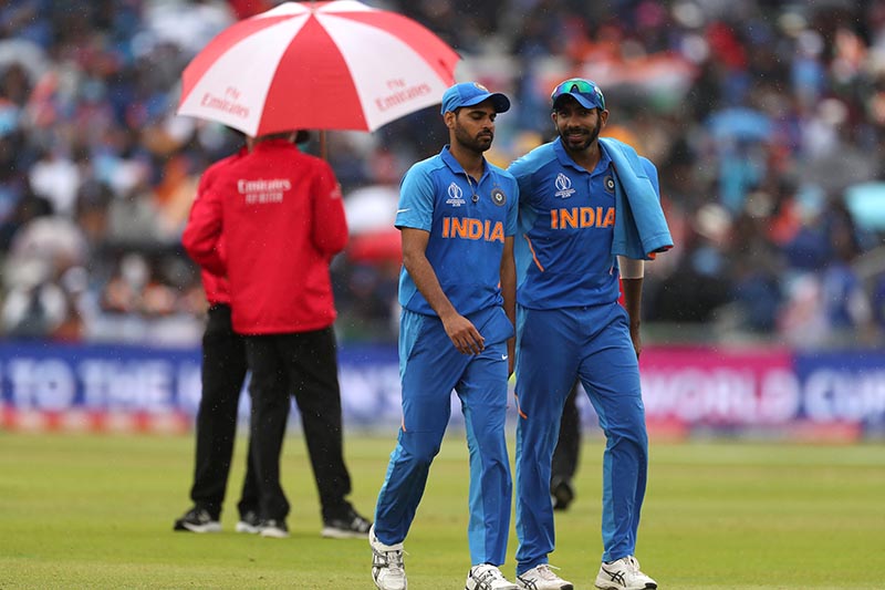 India's Bhuvneshwar Kumar and Jasprit Bumrah as play is stopped due to rain during the ICC Cricket World Cup Semi Final match between India and New Zealand, at  Old Trafford, in Manchester, Britain, on July 9, 2019. Photo: Action Images via Reuters