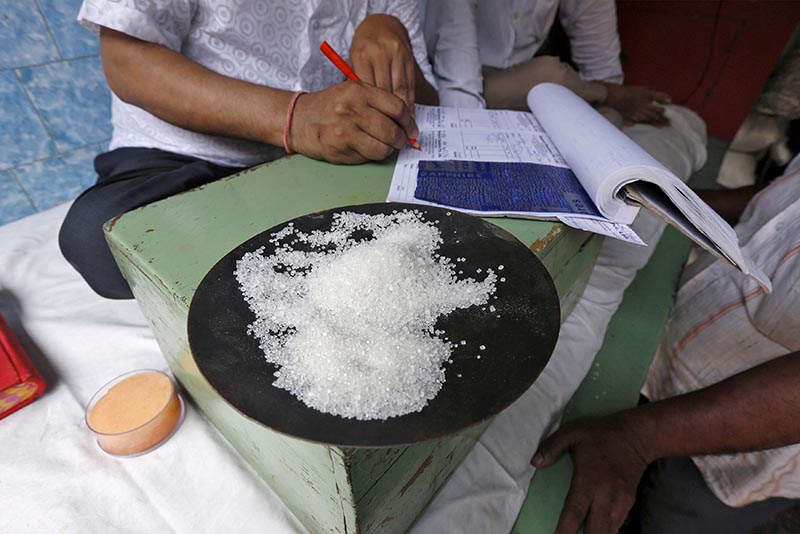 FILE - A sample of sugar crystals are seen on the desk of a trader at a wholesale market in Kolkata, India April 26, 2016. Photo: Reuters
