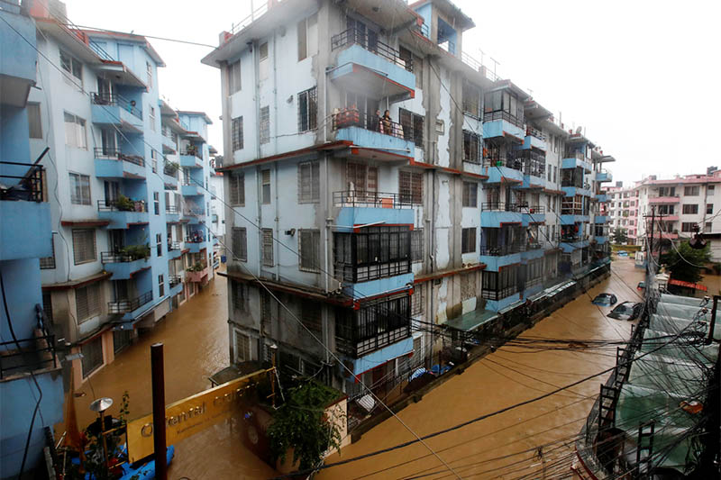 Residents look from a balcony to the flooded colony in Kathmandu, on Friday,July 12, 2019. Photo: Reuters