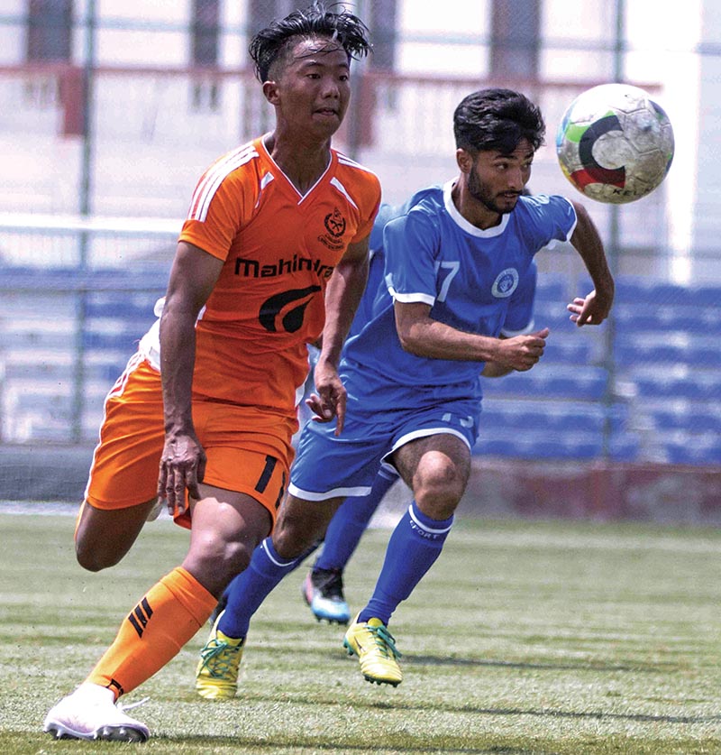 Ranjan Pun (left) of Nepal APF Club vies for the ball with Abhishek Karki of Three Star Club during their Lalit Memorial U-18 Championship match at the ANFA Complex grounds in Lalitpur on Monday. Photo: THT