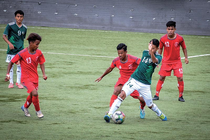 Player of New Road Team (green jersey) and Machhindra Football Club vie for the ball during their Lalit Memorial U-18 Football Championship match in Lalitpur on Sunday. Photo: Naresh Shrestha / THT