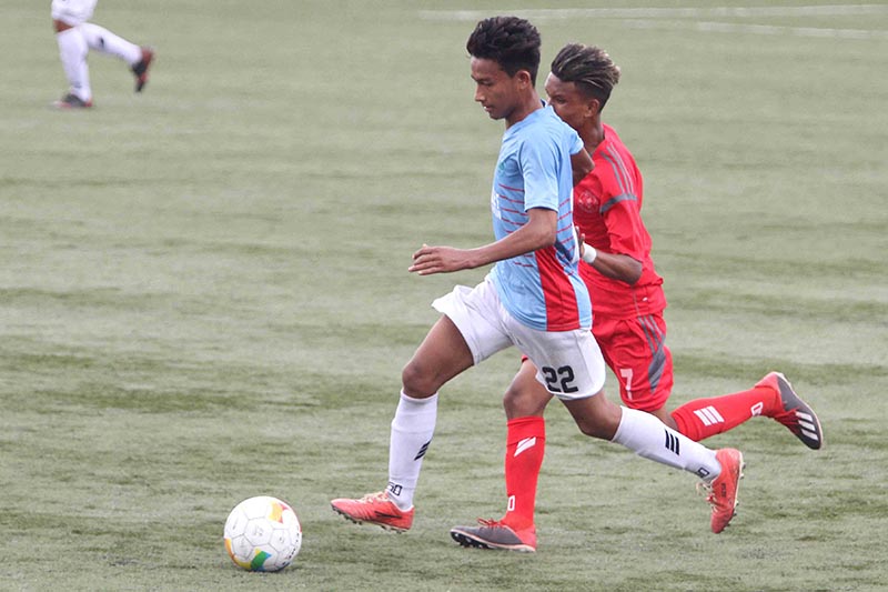 Players of Chyasal Youth Club (left) and Machhindra Football Club vie for the ball during their Lalit Memorial U-18 Football Championship match in Lalitpur on Thursday, July 11, 2019. Photo: Udipt Singh Chhetry/THT