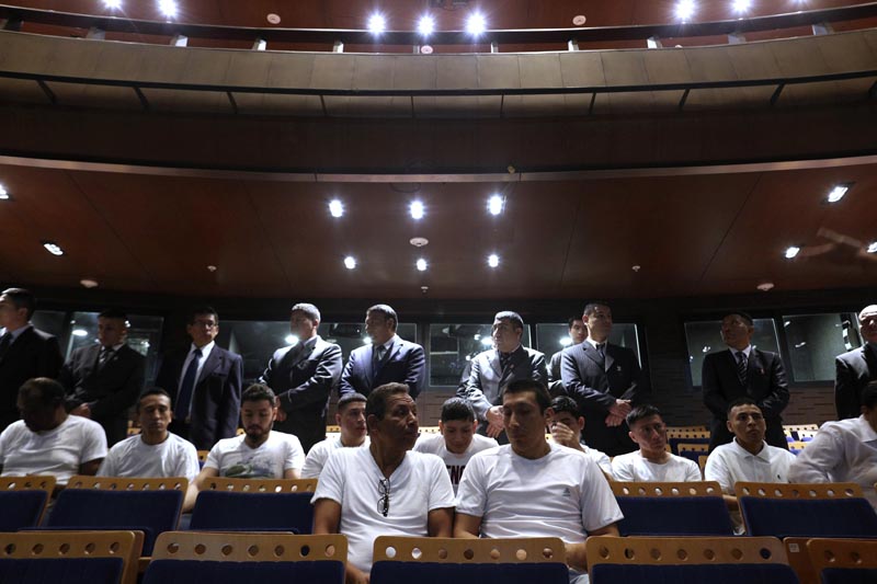 Guards dressed in suits keep an eye on inmates who wait for the start of a classical music session with the symphony orchestra in the national theater in Lima, Peru, July 19, 2019. Photo: AP