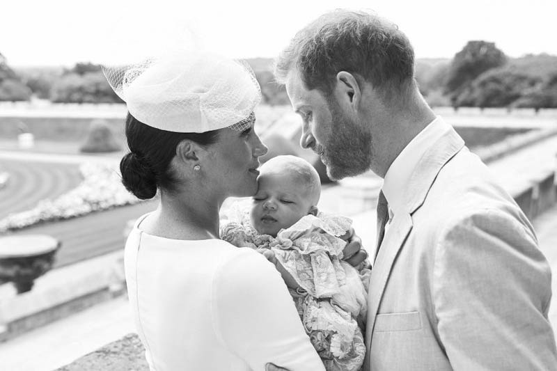 This is an official christening photo released by the Duke and Duchess of Sussex on Saturday, July 6, 2019, showing Britain's Prince Harry, right and Meghan, the Duchess of Sussex with their son Archie Harrison Mountbatten-Windsor at Windsor Castle with with the Rose Garden in the background, in Windsor, England. Photo: AP