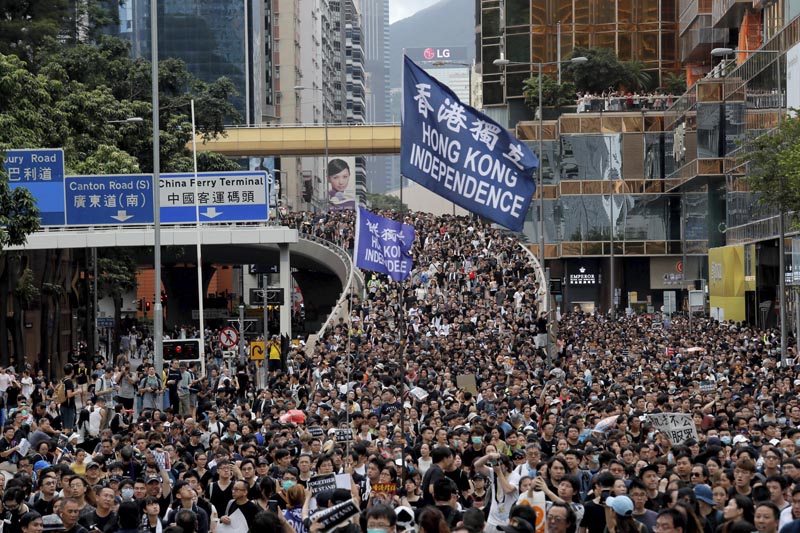 Protesters march with a flag calling for Hong Kong independence in Hong Kong on Sunday, July 7, 2019. Photo: AP