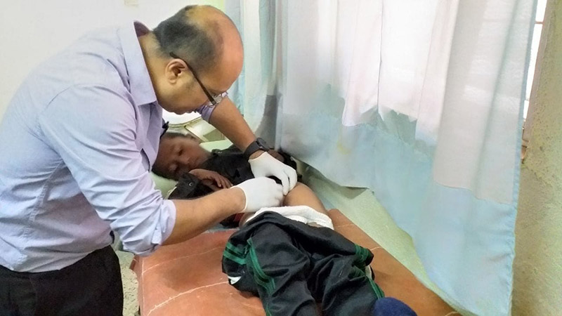 Ramlal Sarki, 10, being checked by a doctor, in Kathmandu. Photo: Prakash Singh/THT