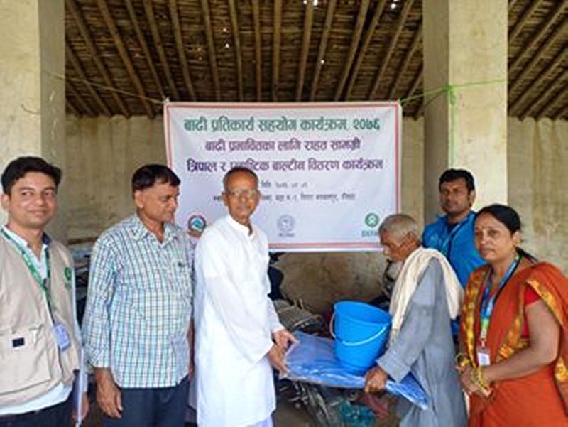 Rautahat District Coordination Committee Coordinator Ram Ekbal Yadav gives away relief to flood victims of Fatuwa Mahespur, in Rajpur Municipality, Rautahat district, on Monday, July 29, 2019. Rural Development Centre Nepal distributed relief to flood victims of Ishnath and Rajpur municipalities in collaboration with OXFAM Nepal in RautahatPhoto: Prabhat Kumar Jha/THT