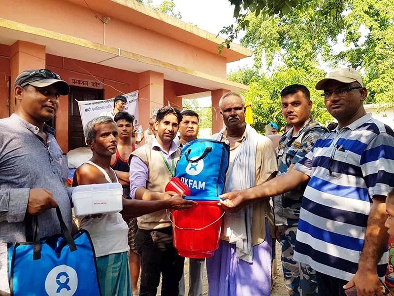 Relief Distribution Programme Coordinator Bijay Sah provides flood victims with relief items, in Ishanath Municipality, Rautahat district, on Monday, July 29, 2019. Photo: Prabhat Kumar Jha/THT