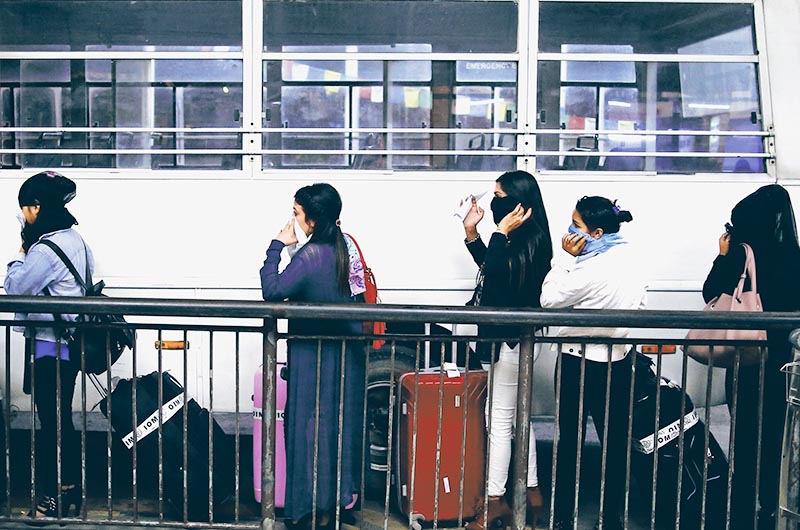 Women who were working in a dance bar in Kenya heading towards a vehicle after arriving at Tribhuvan International Airport, in Kathmandu, on Thursday, July 18, 2019. Photo: Skanda Gautam/THT