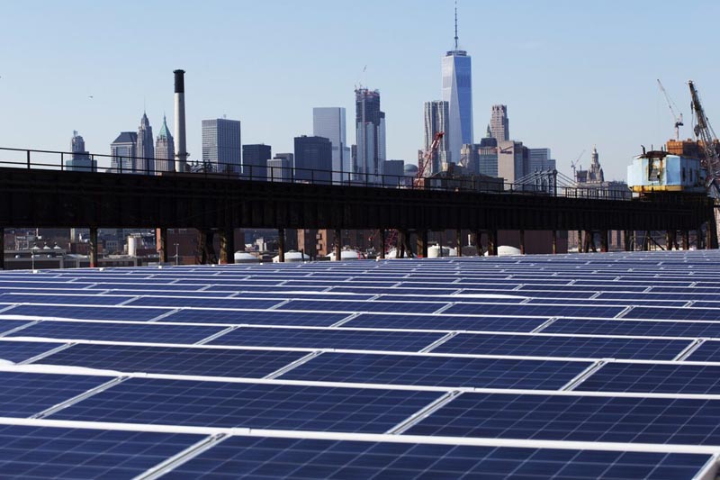 FILE - In this Feb. 14, 2017, file photo, a rooftop is covered with solar panels at the Brooklyn Navy Yard in New York. The Manhattan skyline is at top. Photo: AP