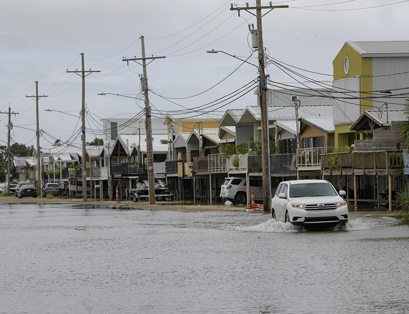 An SUV travels down Breakwater Drive in New Orleans, Friday, July 12, 2019, near the Orleans Marina as water moves in from Lake Pontchartrain from the storm surge from Tropical Storm Barry in the Gulf of Mexico. Photo: AP