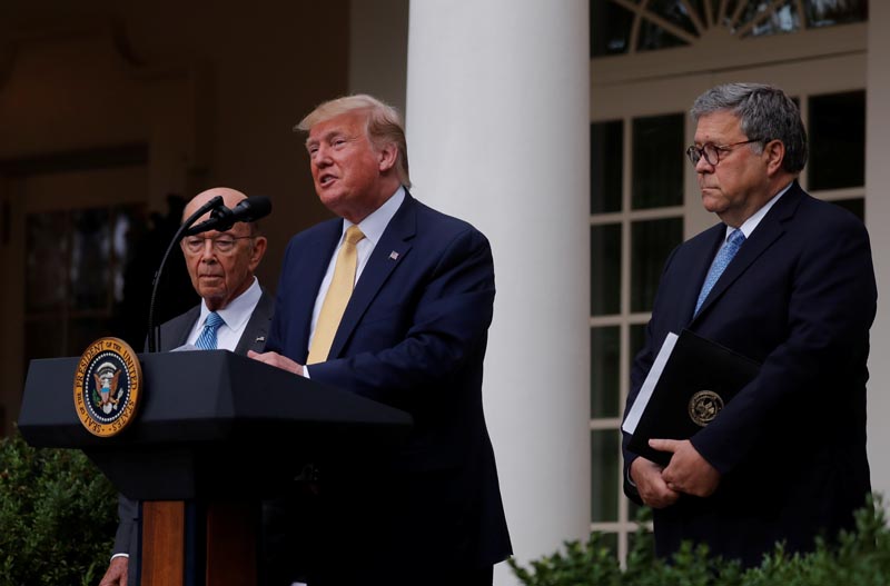 US President Donald Trump stands with Commerce Secretary Wilbur Ross and Attorney General Bill Barr as he announces his administration's efforts to gain citizenship information during the 2020 census during an event in the Rose Garden of the White House in Washington, US, July 11, 2019. Photo: Reuters