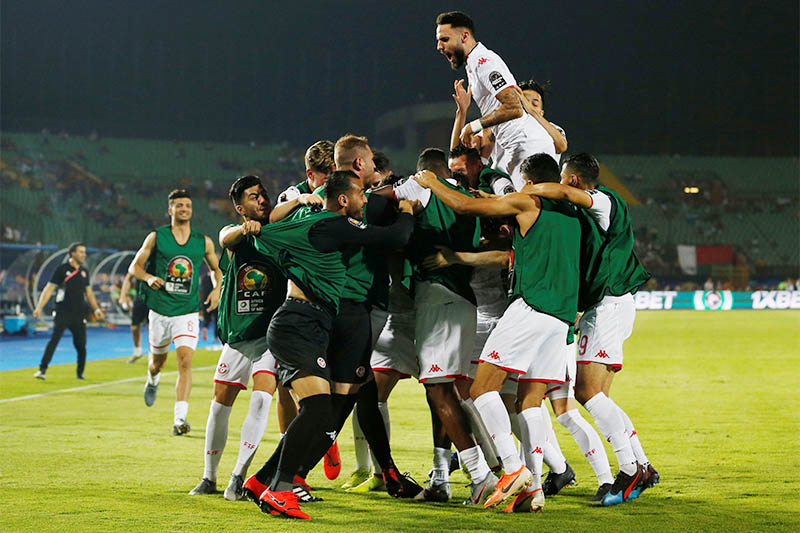 Tunisia's Youssef Msakni celebrates scoring their second goal with team mates. Photo: Reuters
