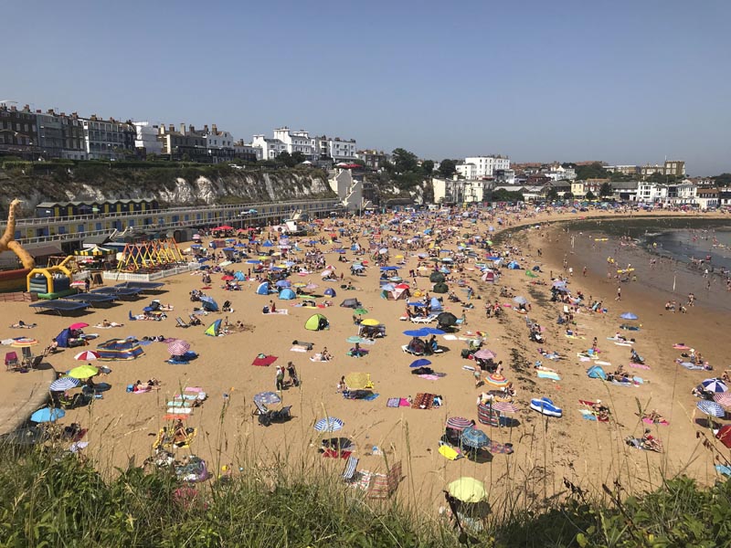 People flock to Broadstairs beach in Kent, England, Thursday July 25, 2019. Photo: Wesley Johnson/PA via AP