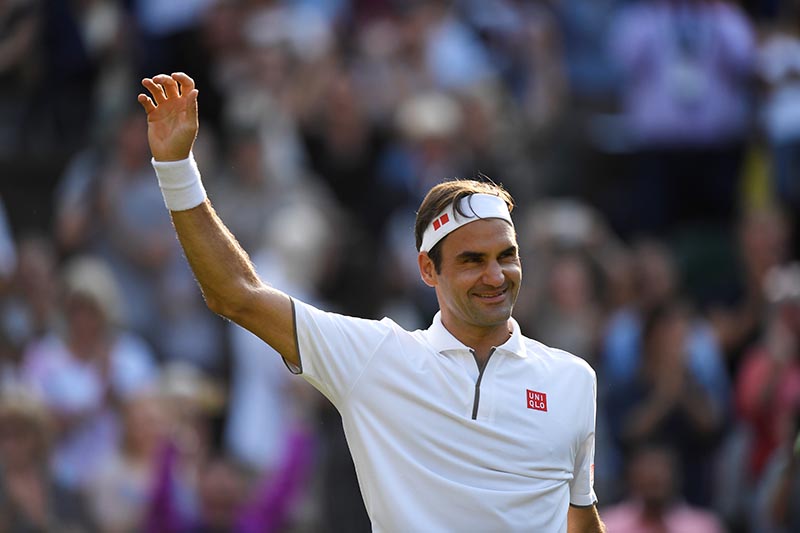 Switzerland's Roger Federer celebrates after winning his quarter final match against Japan's Kei Nishikori  during the Wimbledon, at  All England Lawn Tennis and Croquet Club, in London, Britain, on July 10, 2019 . Photo: Reuters