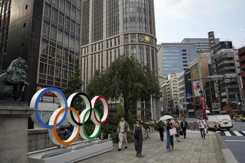 In this Monday, August 19, 2019, photo, people walk past the Olympic rings in Tokyo. Photo: AP