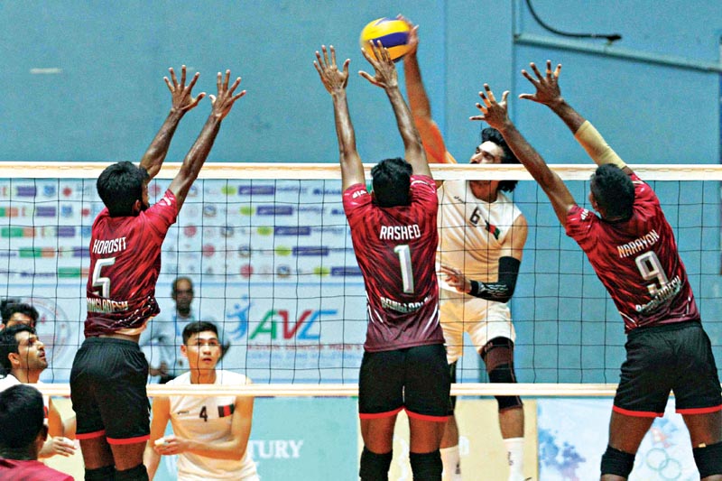 Zadran Omid (second from right) skipper of Afghanistan jumps to attempt a spike shot against Bangladesh playrs during the AVC Men's Senior Central Zone Volleyball Championship matches at Nepali Army Sports Complex covered hall, Lagankhel in Lalitpur on Tuesday. Photo: Udipt Singh Chhetry/THT