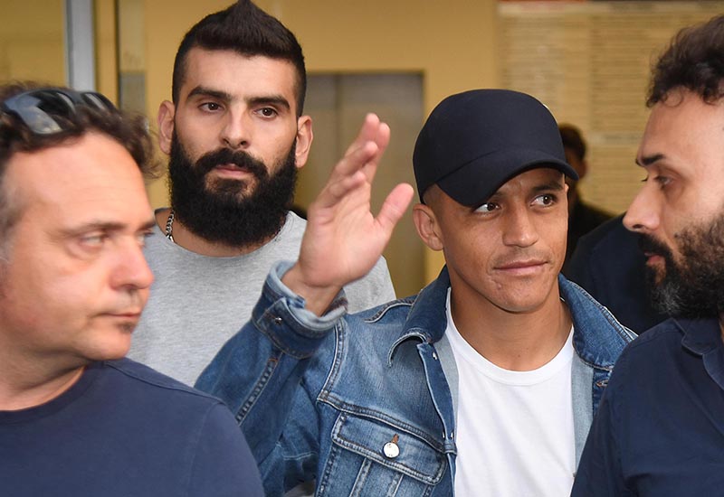 Alexis Sanchez (second from right) waves to fans upon his arrival at the Coni (Italian Olympic Committee) office for medical checks, in Milan, Italy, on Wednesday, August 28, 2019. Sanchez will leave Manchester united on a loan deal with the Italian Serie A soccer team, Inter Milan, Italian news agency ANSA said. Photo: Daniel Dal Zennaro/ANSA via AP