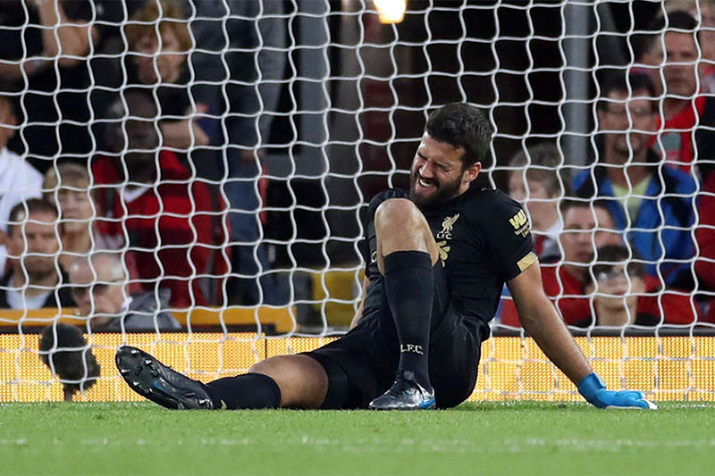 Liverpool's Alisson reacts after sustaining an injury. Photo: Reuters
