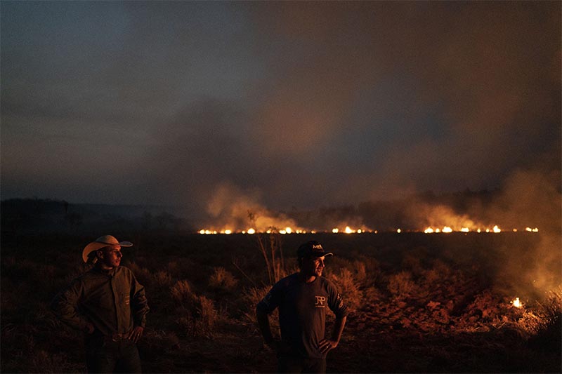 Neri dos Santos Silva (centre) watches an encroaching fire threat after digging trenches to keep the flames from spreading to the farm he works on, in the Nova Santa Helena municipality, in the state of Mato Grosso, Brazil, on Friday, August 23, 2019. Under increasing international pressure to contain fires sweeping parts of the Amazon, Brazilian President Jair Bolsonaro on Friday authorized use of the military to battle the massive blazes. Photo: AP