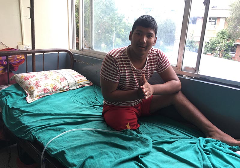 Arjun Bhandara, 21, gesturing after emerging from coma at TU Teaching Hospital, in Kathmandu, on Wednesday. Photo: THT