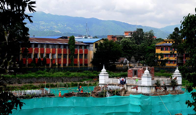 Construction work being carried out in Rani Pokhari,Kathmandu, on Monday. Restoration of the Balgopaleshwor temple in the middle of the pond is also underway.