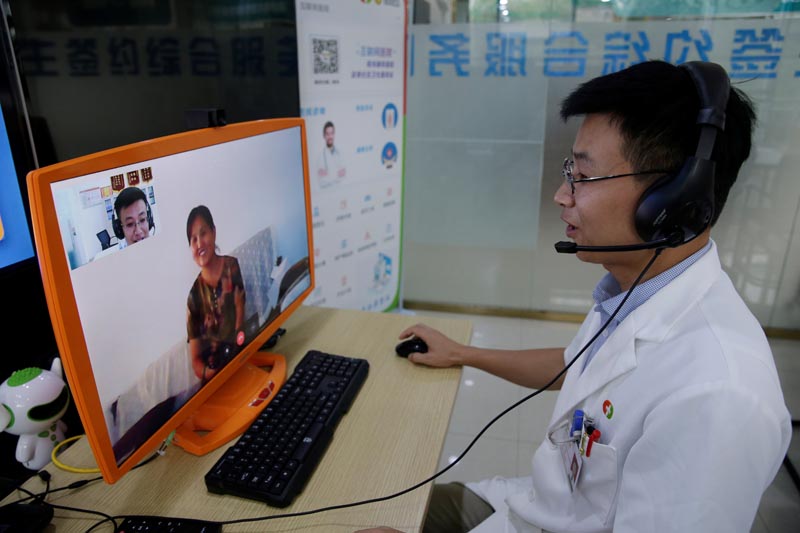 Doctor Cao Liangliang speaks with an elderly client Zhao Xi'e via Lanchuang's elderly care system at Zhuojing Healthcare Centre, one community medical service provider connected to the company's network in Weifang, Shandong province, China, July 25, 2019. Photo: Reuters