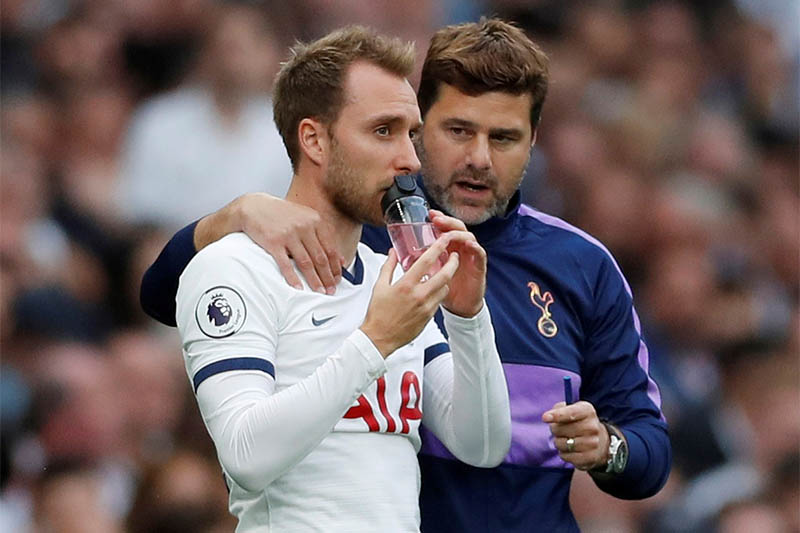 FILE: Tottenham's Christian Eriksen with manager Mauricio Pochettino before coming on to replace Harry Winks. Photo: Reuters