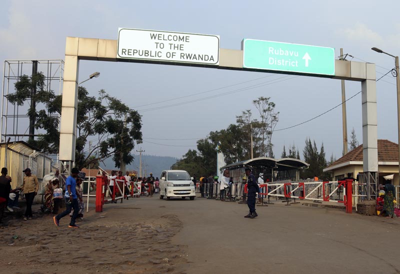 People walk past the Congo side of the Poids Lourd checkpoint at the border between Congo and Rwanda, Thursday, August 1, 2019. Photo: AP