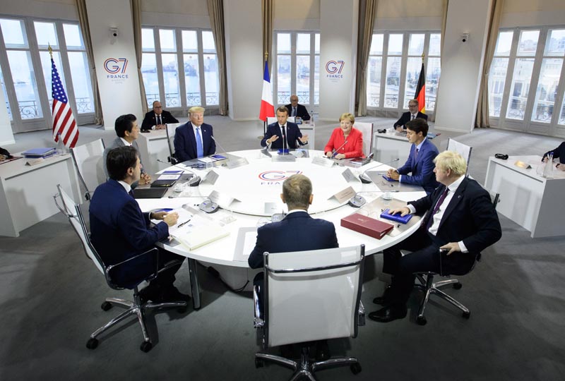 President of the European Council Donald Tusk, clockwise from center front, Italian Prime Minister Giuseppe Conte, Japan Prime Minister Shinzo Abe, US President Donald Trump, President of France Emmanuel Macron, German Chancellor Angela Merkel, Canadian Prime Minister Justin Trudeau, and British Prime Minister Boris Johnson take part in a working session with G7 leaders on the second day of the G-7 summit in Biarritz, France Sunday, August 25, 2019. Photo: Sean Kilpatrick/The Canadian Press via AP