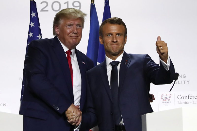 US President Donald Trump and French President Emmanuel Macron shake hands after their joint press conference at the G7 summit Monday, August 26, 2019 in Biarritz, southwestern France