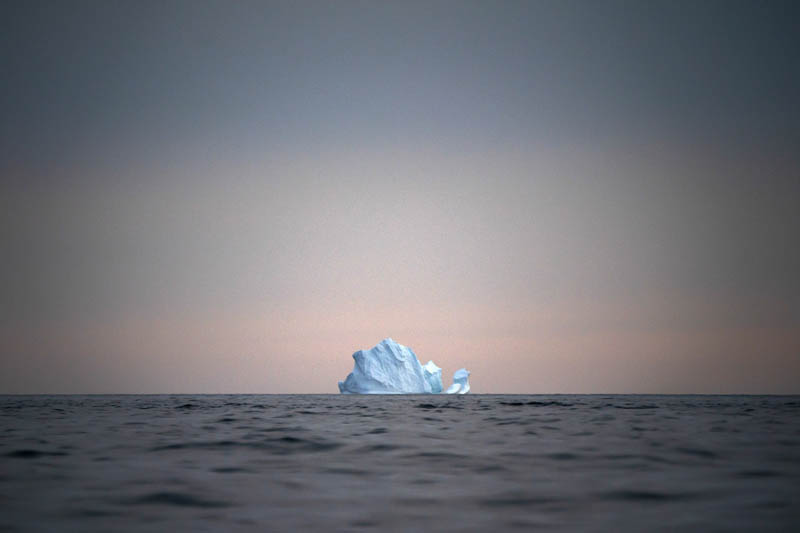A large iceberg floats away as the sun sets near Kulusuk, Greenland, August 15, 2019. Photo: AP