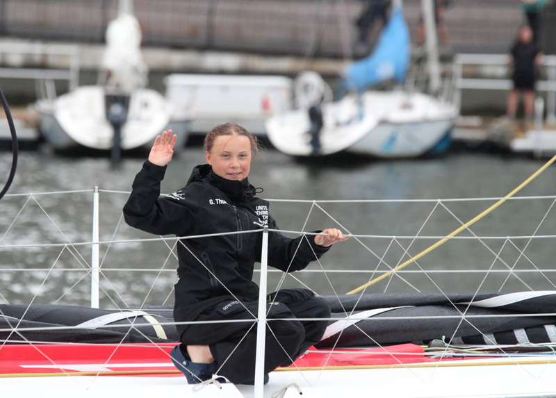 Greta Thunberg, a 16-year-old Swedish climate activist, waves after sailing in New York harbour aboard the Malizia II, Wednesday, August 28, 2019.