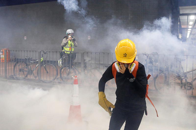 An anti-extradition bill protester reacts after tear gas was fire by the police during a demonstration in Tai Wai in Hong Kong, China, August 10, 2019. Photo: Reuters