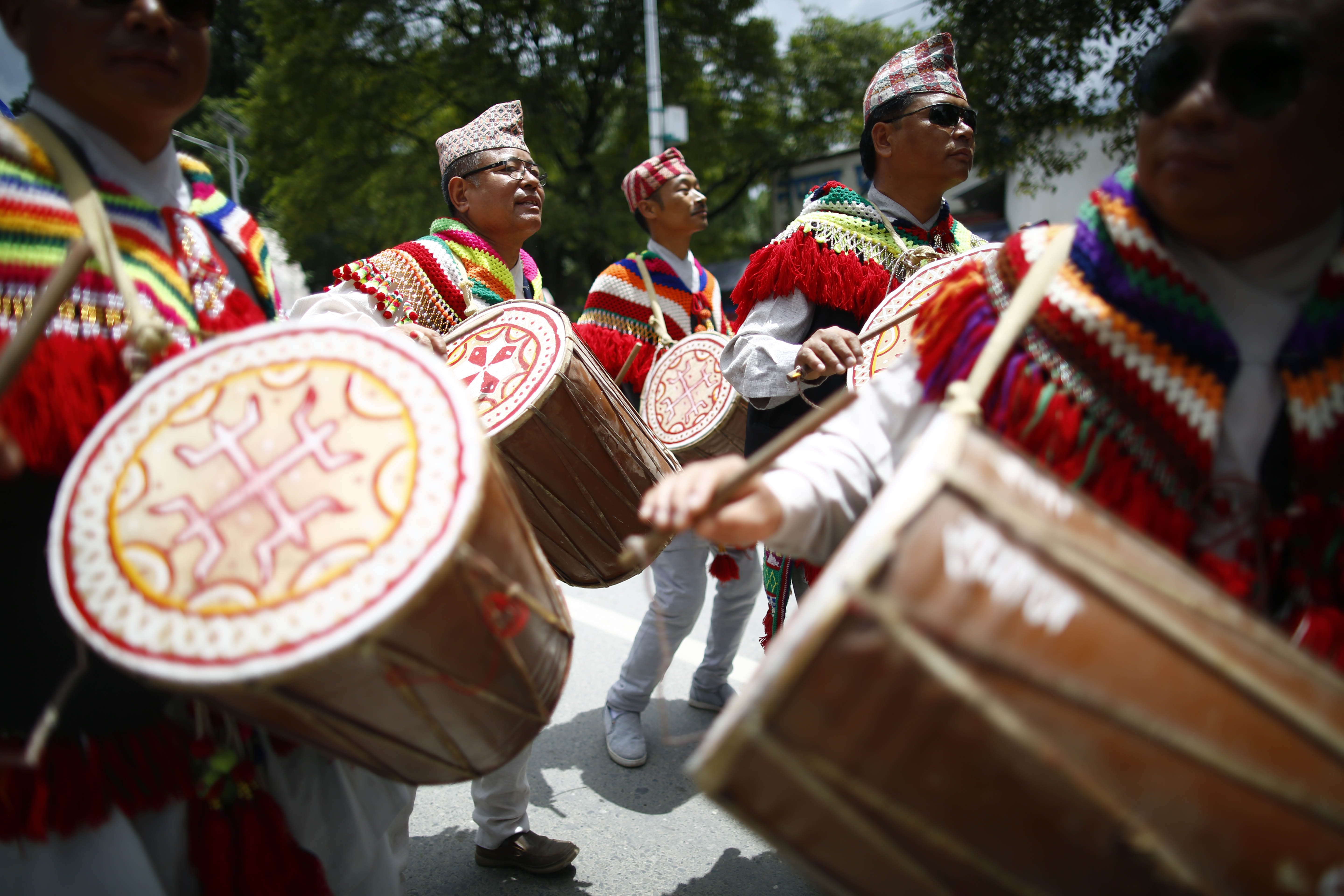 People belonging to the indigenous community, dressed in cultural attire, play traditional drums during a rally on World's Indigenous Peoples Day, in Kathmandu, on Friday, August 09, 2019. Photo: Skanda Gautam/THT