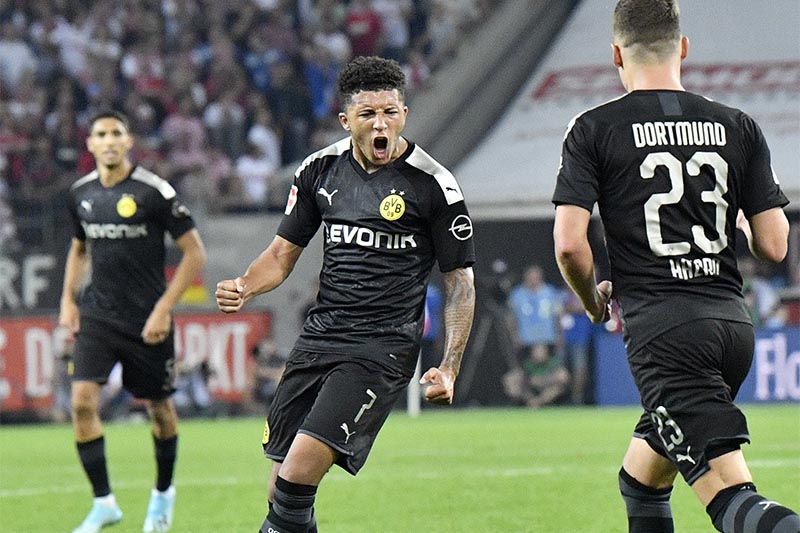 Dortmund's Jadon Sancho (centre) celebrates with teammates after scoring his side's opening goal during the German Bundesliga soccer match between FC Cologne and Borussia Dortmund in Cologne, Germany, on Friday, August 23, 2019. Photo: AP