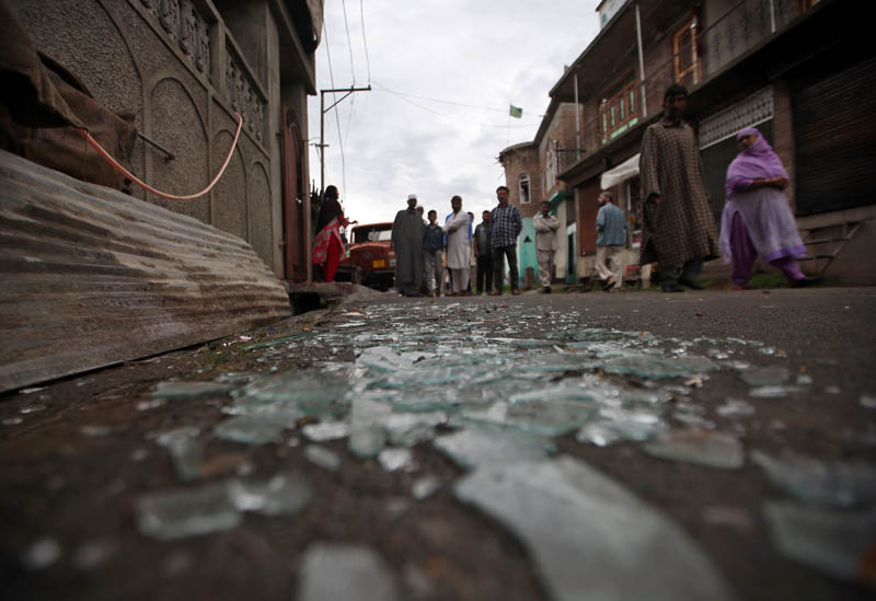 Kashmiris walk past broken window glass after clashes between protesters and the security forces on Friday evening, during restrictions following the scrapping of the special constitutional status for Kashmir by the Indian government, in Srinagar August 17, 2019. Photo: Reuters