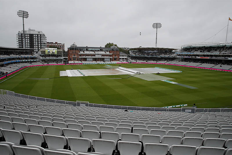 General view of covers on the field as rain delays play. Photo: Reuters